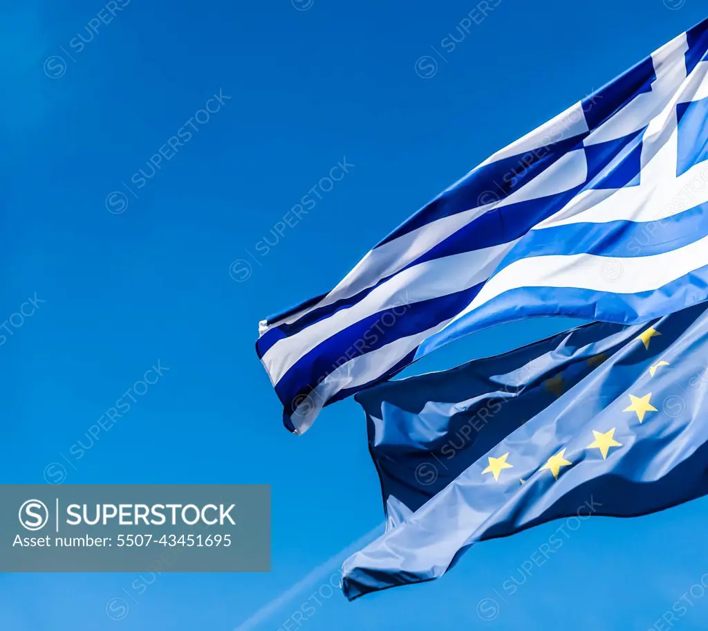 Flags of Greece and European Union on blue sky background, politics of Europe