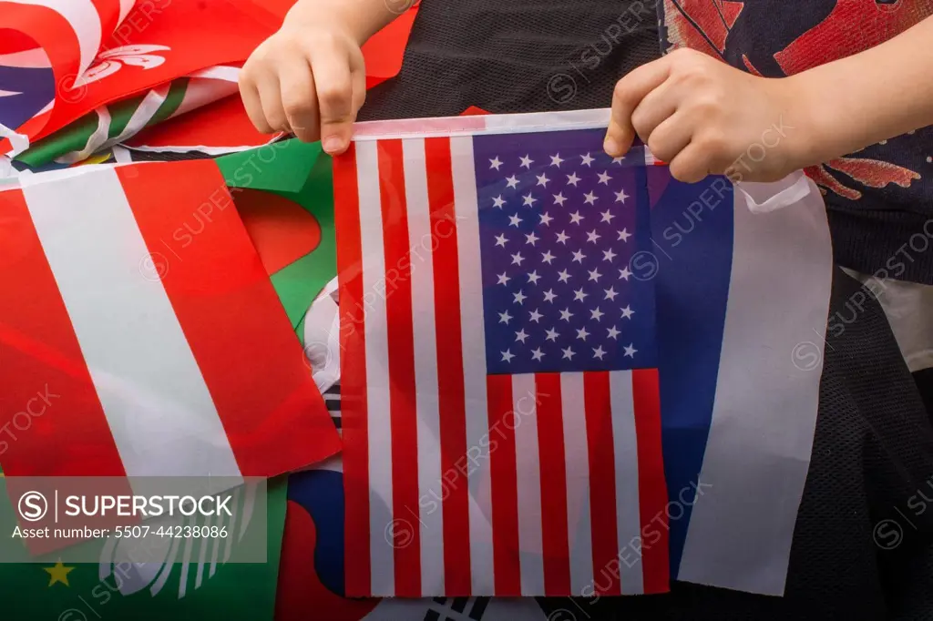 Child hand holding an American flag in hand