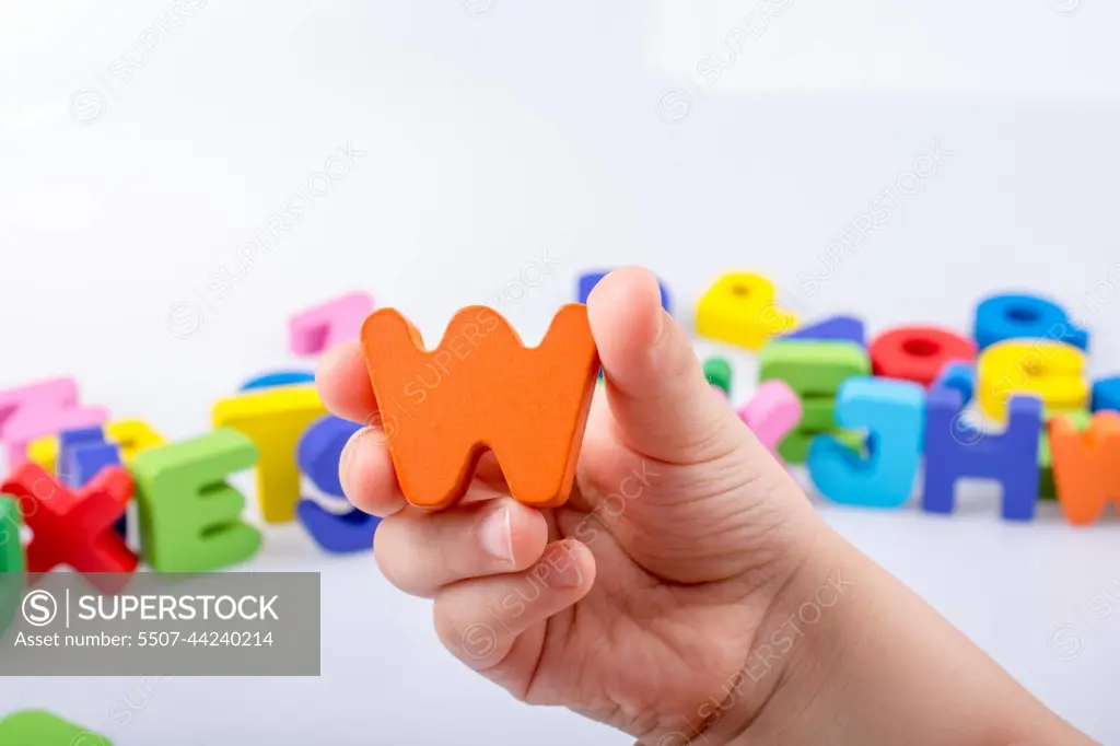 Hand holding Letter cube  W of  Alphabet