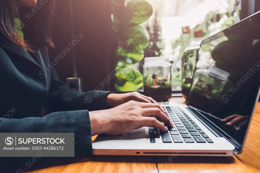 Young businesswoman is working by typing on his computer laptop