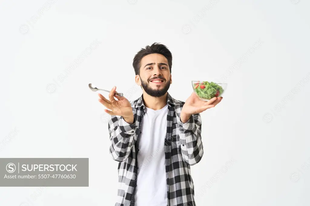 man in plaid shirt eating salad healthy food