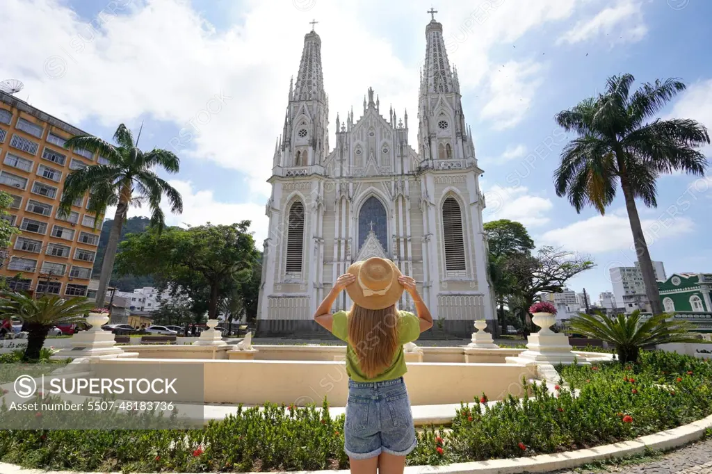 Tourism in Brazil. Back view of young traveler woman looking the Vitoria Cathedral in Espirito Santo State, Brazil.