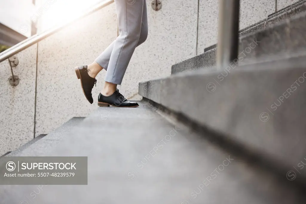 Stairs, morning person and legs walk, travel or on urban journey, outdoor commute or trip to work, destination or job. Town steps, arrival and closeup shoes, feet or agent climbing building staircase