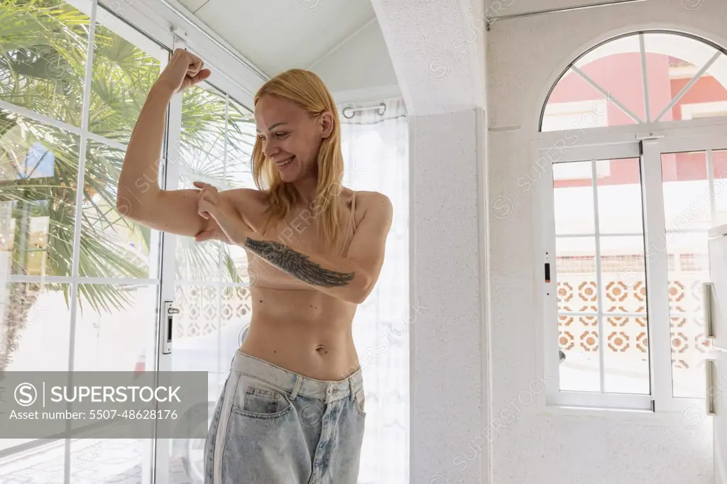 The concept of a successful diet. Cropped shot of a young woman in oversized jeans showing the resul