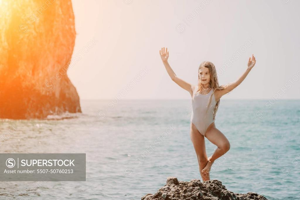 Woman And Her Daughter Practicing Balancing Yoga Pose On One Leg Up  Together On Rock In The Sea. Silhouette Mother And Daughter Doing Yoga At  Beach Stock Photo, Picture and Royalty Free