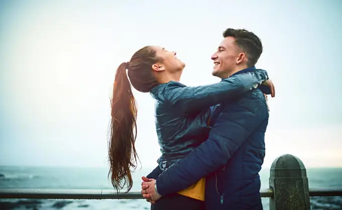 Nothing feels better than love. Shot of a happy young couple embracing outdoors.