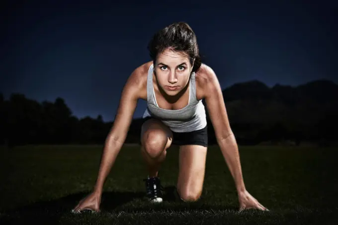 The start to a great race. A young woman at the starting line of a race.