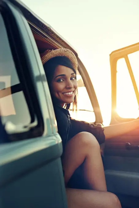 Road tripping it right through summer. Shot of a young woman enjoying a relaxing roadtrip.