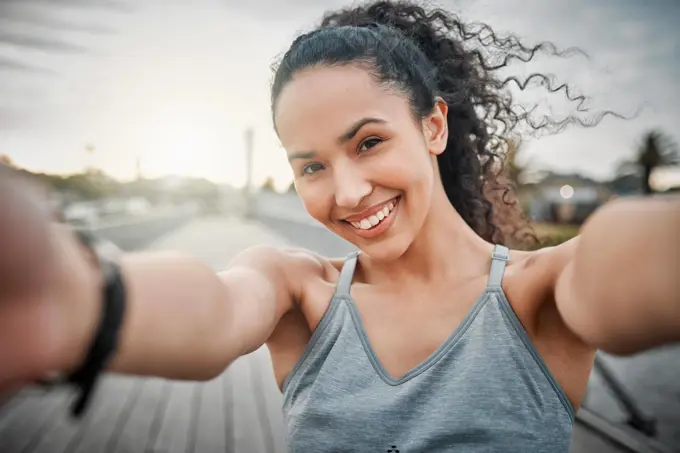 Morning run Complete. Cropped portrait of an attractive young female athlete taking selfies during her morning run outside.