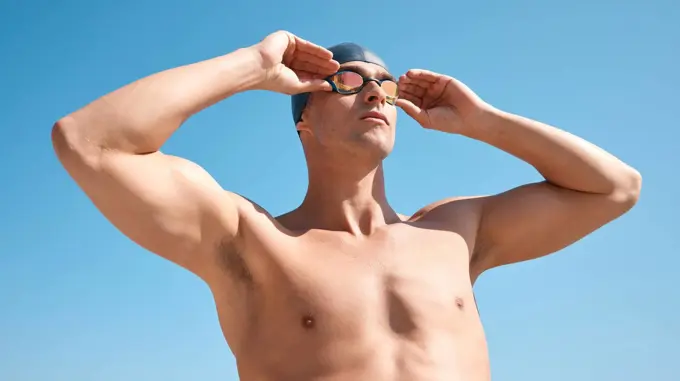 Ready to dive in. a handsome young male athlete swimming in an olympic-sized pool.