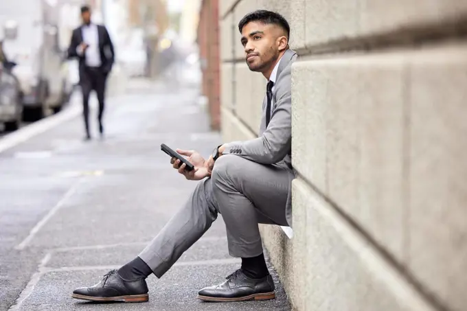 Hes got a lot to think about. Full length shot of a handsome young businessman traveling through the city on his morning commute into work.