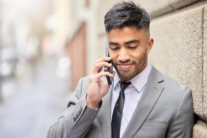 Making big calls in the city. a handsome young businessman traveling through the city on his morning commute into work.