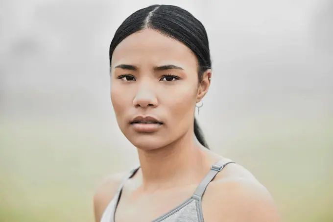 Keep looking forward. Cropped portrait of an attractive young female athlete exercising outside.