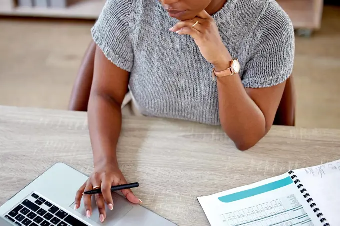 Getting the job done. a businesswoman working on her laptop.