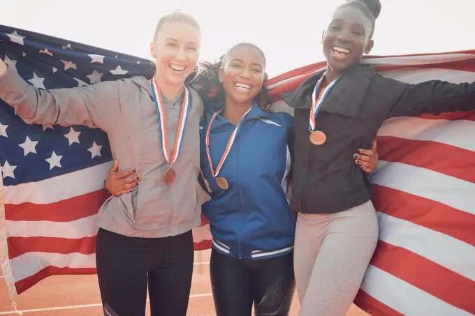 Cherish the team you have. a group of female athletes holding an american flag.