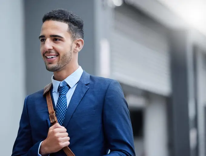 Heading in to work for the day. a handsome young businessman on his morning commute into work.