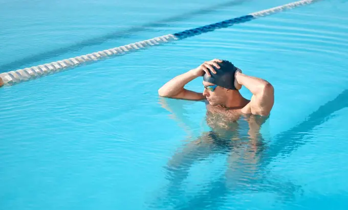 Thinking about the upcoming competition. a handsome young male athlete swimming in an olympic-sized pool.