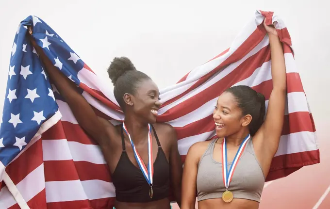 Theyve got that winning mentality. two attractive young female athletes celebrating their countrys victory.