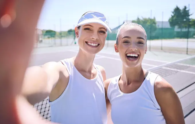 Selfie taking team of female tennis players on the court after a game, match or tournament portrait. Fit sporty teammates, athletes or professionals relax after being active, exercise and training