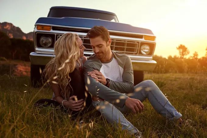 Roadtripping in the name of love. an affectionate young couple on a roadtrip.