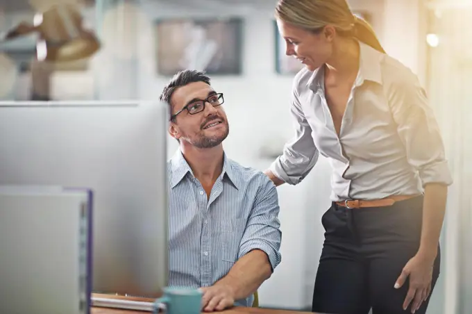 Shes a helpful businesswoman. two colleagues working together on a computer.