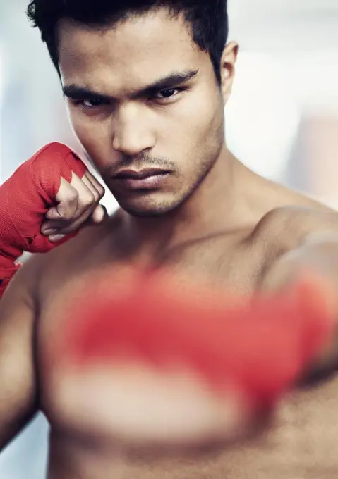 Hes dedicated to the sport of boxing. a young male boxer training.