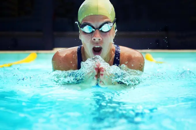 Born to swim. a young female swimmer training by the pools.