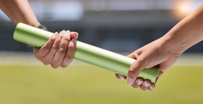 Teamwork, relay race and hands on baton, fitness competition and women running on track and field. Sports, wellness and woman runner team with trust and collaboration for winning at race track event.