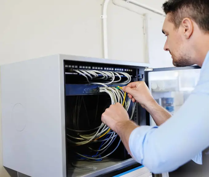 Getting to the root of the problem. a computer engineer working on a server.