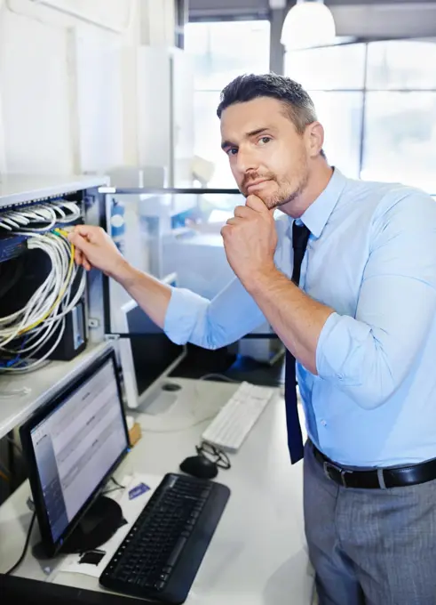 Yep, theres a problem...Portrait of a computer engineer working on a server.