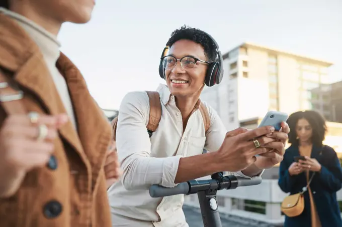 Phone, electric scooter and transport with a black man in the city on his commute into work. Technology, street and communication with a male employee typing a message while on a scooter for travel