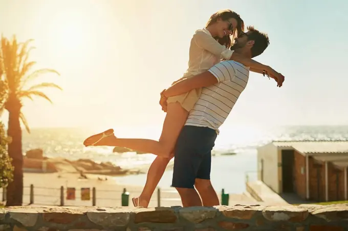 When summer love leads to true love. a happy young couple embracing on a summers day outdoors.