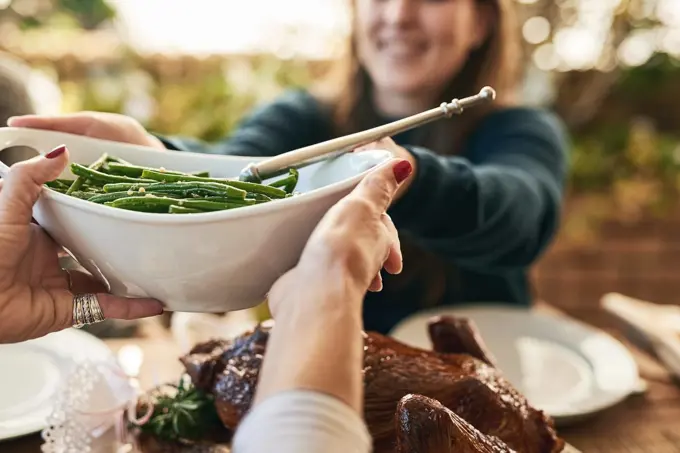 Food, hands and couple share healthy vegetables at dining room table for lunch, dinner and healthy meal together. Friends, healthy food and meal at table for quality time and bonding in family home