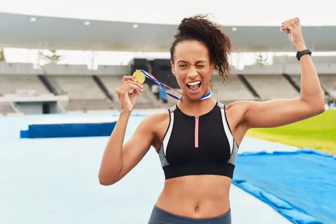 Its official. Im the best. Cropped portrait of an attractive young female athlete celebrating while out on the track.