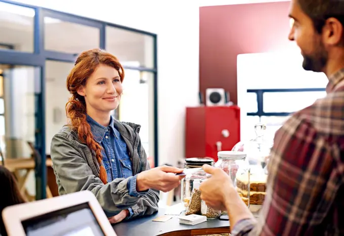 Woman smile, customer and credit card at a coffee shop for payment with a order at restaurant. Female person, happiness and diner to pay and buy at cafe with male store assistant and barista