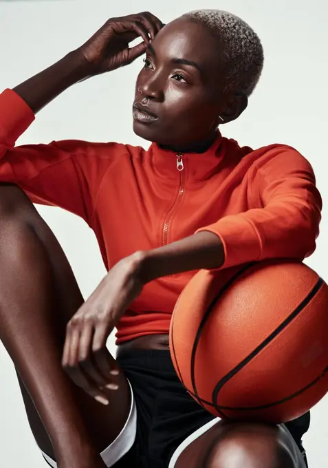 Whats life without basketball. Studio shot of an attractive young woman playing basketball against a grey background.