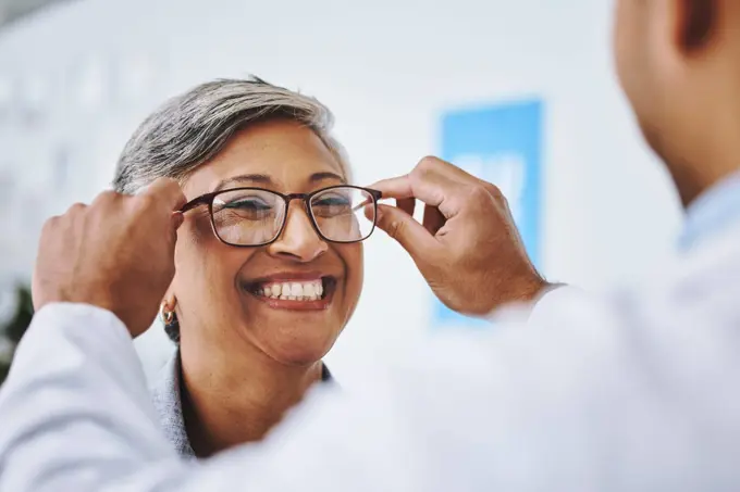 Optometry, smile and woman with prescription glasses, optician and helping client with product. Female person, employee and optometrist assist with eyewear, clear vision and buying new spectacles