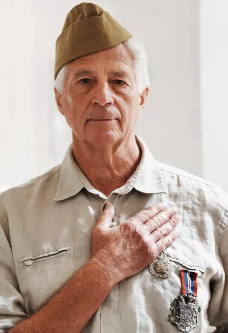 He has pledged his loyalty to the country. A senior war veteran looking at the camera wearing his uniform.