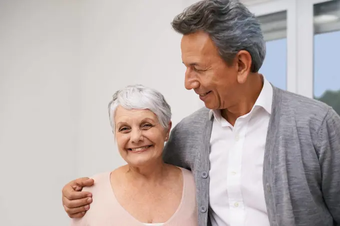 Loving retirement. an affectionate elderly couple at home.