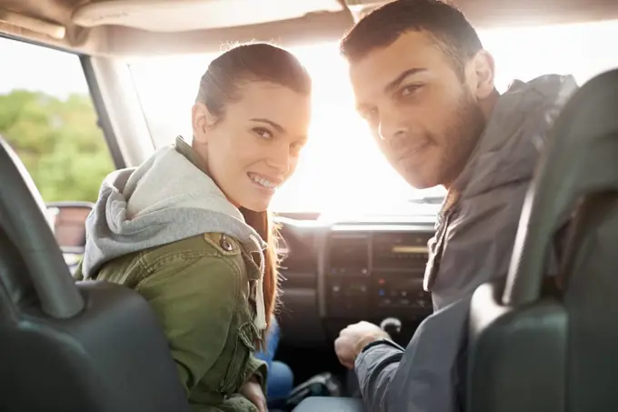 Theres nothing but sunshine and happiness on our roadtrip. Portrait of a young couple on a roadtrip.