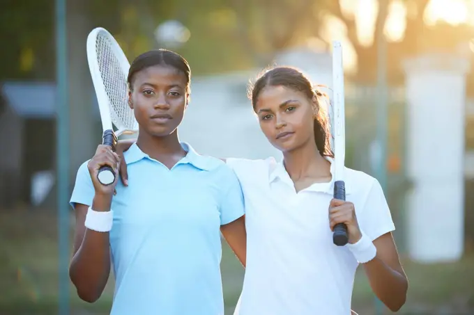 Portrait, tennis and teamwork with sports women standing on a court outdoor together ready for a game. Fitness, collaboration or doubles partner with a serious female athlete and friend outside