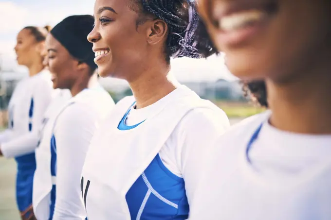 Sports, netball and team of women with smile ready for training, exercise and fitness workout on court. Diversity, teamwork and row of happy girl athletes with motivation for game, match and practice