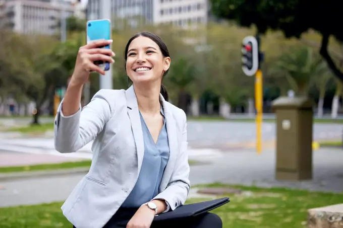 Business woman, selfie and travel with commute to work, communication and social media post in city. Young female professional, smile in picture with happiness, technology and urban with mockup space