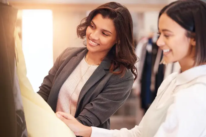 Fashion, retail and customer friends shopping in a mall together while searching for sales in a clothing store. Consumerism, smile, or happy with a woman and friend in a boutique shop to buy clothes