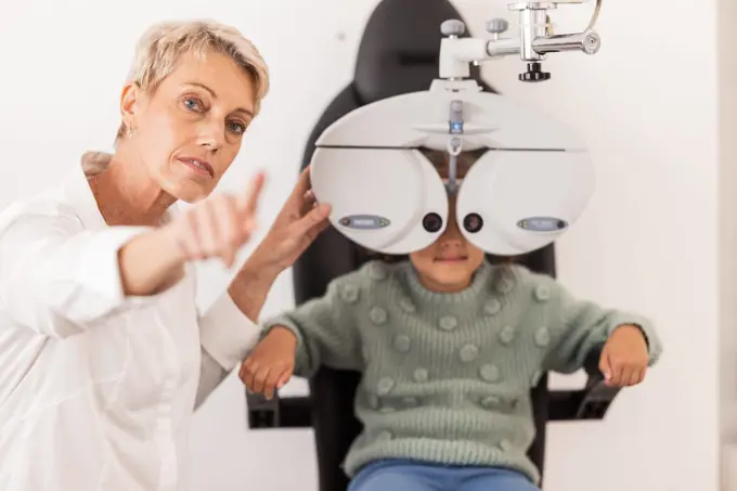 Vision, eye and test with a child at optometry exam with a specialist doctor in a clinic for glasses. Ophthalmology, optometry and medical expert eye test with little girl for eye health and eye care