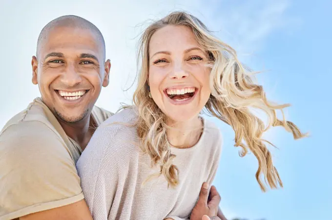 Love, blue sky and diversity couple hug, laugh and enjoy fun quality time together on travel vacation date. Happy, smile and romantic black man, woman or excited people bond on Toronto Canada holiday