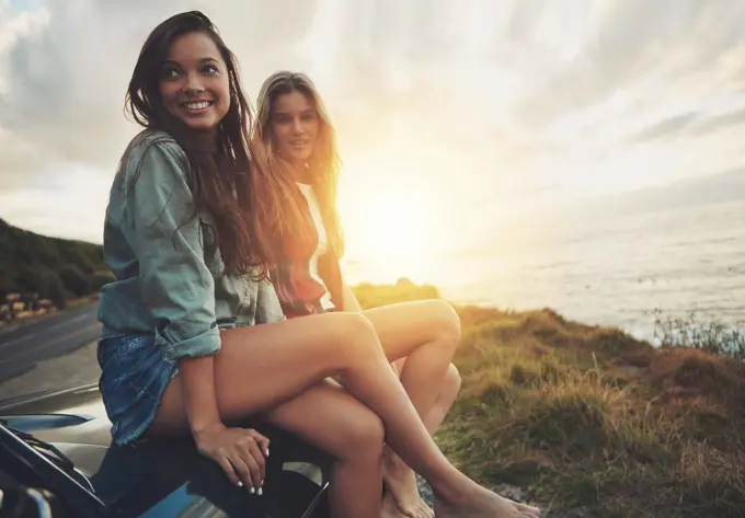 Friends at sunset, women on car with travel to beach, road trip portrait and outdoor with nature and sea holiday. Adventure mockup, freedom and gen z youth on summer vacation, happy with lens flare