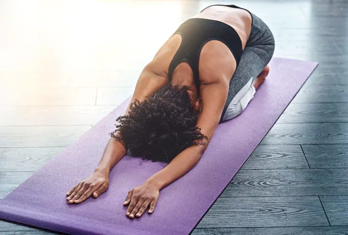 Yoga, workout and wellness with a woman in studio on an exercise mat for inner peace or to relax. Health, fitness and zen with a female athlete or yogi in the childs pose for balance or mindfulness