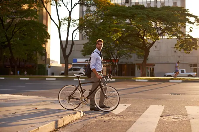 Getting around the green way. a businessman commuting to work with his bicycle.