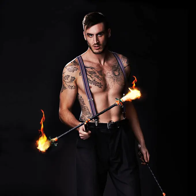 Its getting hot in here. Shot of a performer holding a flaming stick.